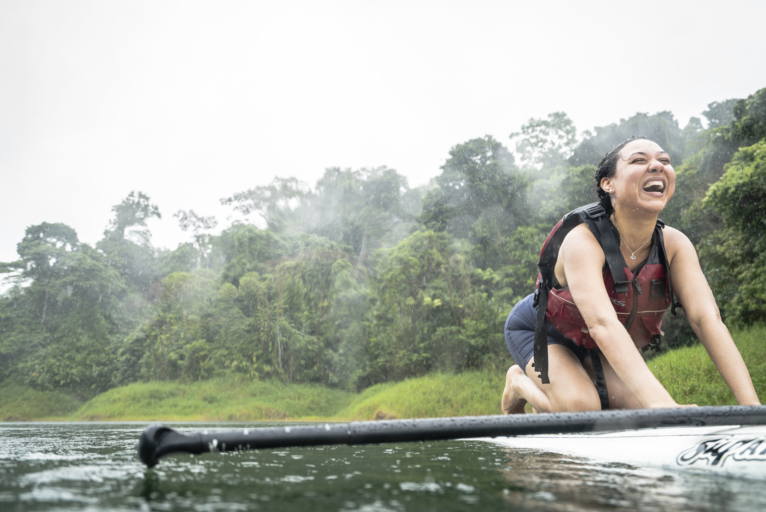 Costa Rica La Fortuna Stand Up Paddle Boarding SUP Yoga Female Traveller Laughing